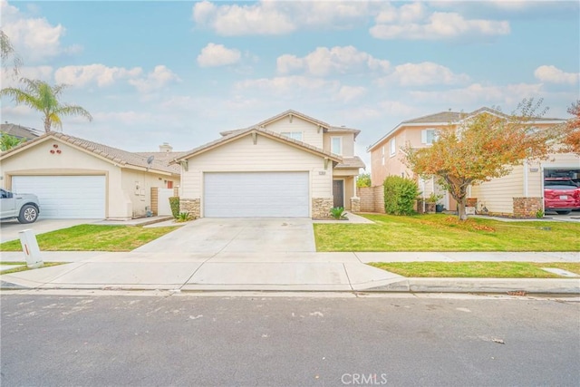 view of front of house featuring a garage and a front lawn