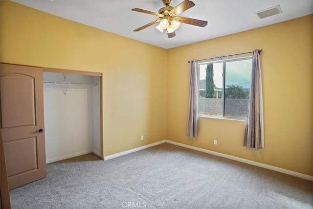 unfurnished bedroom with carpet flooring, ceiling fan, and a closet