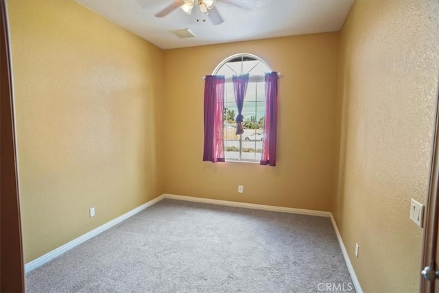 carpeted empty room featuring ceiling fan