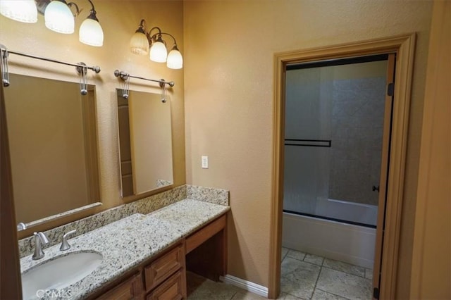 bathroom with vanity and bath / shower combo with glass door