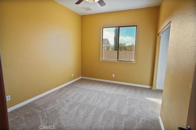 empty room with ceiling fan and carpet floors