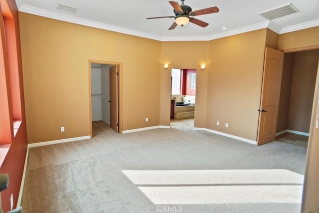 carpeted spare room with crown molding and ceiling fan