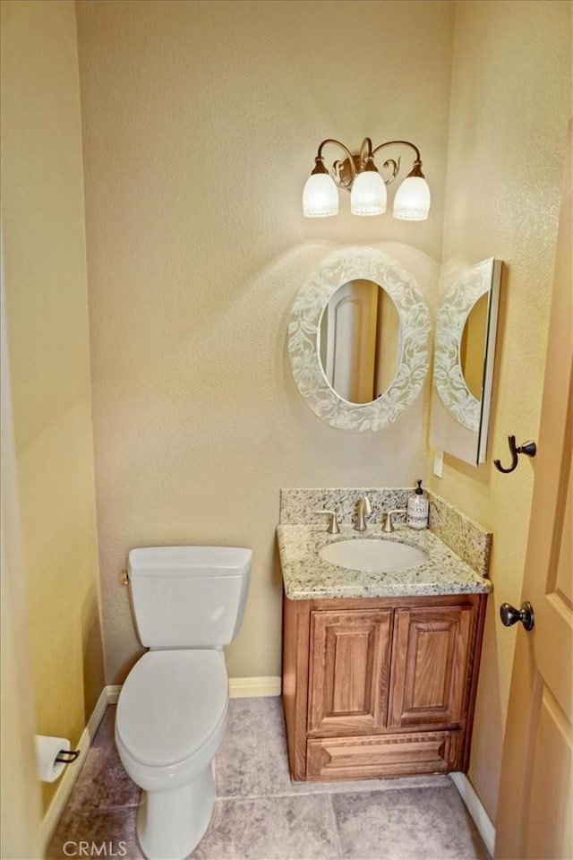 bathroom featuring toilet, vanity, and tile patterned floors