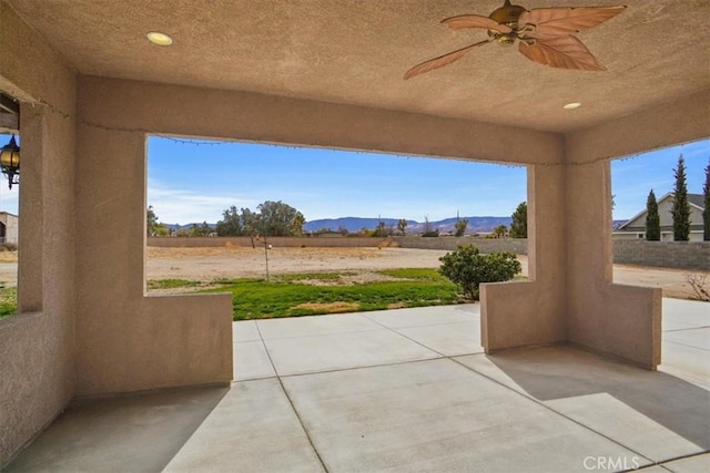 view of patio / terrace featuring ceiling fan and a mountain view