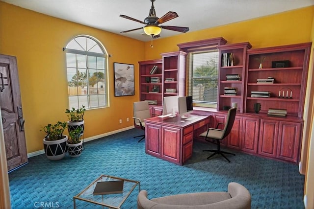 office featuring dark colored carpet, plenty of natural light, and ceiling fan