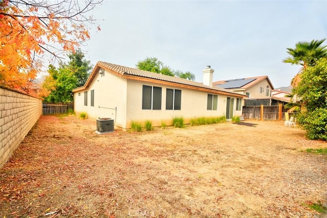 rear view of house featuring central AC unit