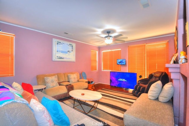 living room with ceiling fan and crown molding