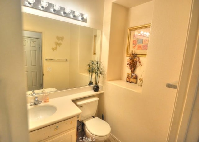 bathroom with toilet and vanity