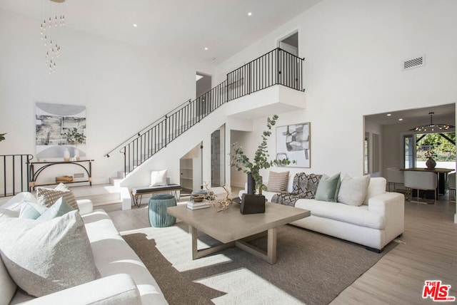 living room with a high ceiling and light wood-type flooring