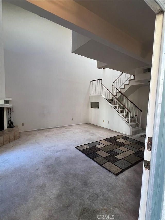 unfurnished living room with a tiled fireplace