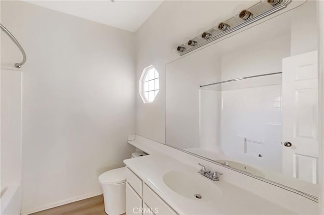 full bathroom with toilet, bathing tub / shower combination, hardwood / wood-style flooring, and vanity