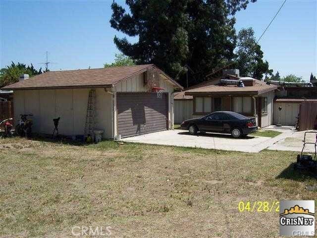 view of property exterior featuring concrete driveway and a yard