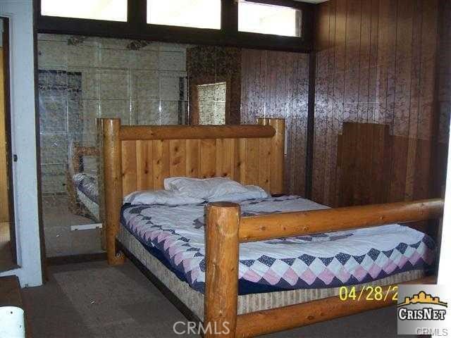 bedroom with wood walls