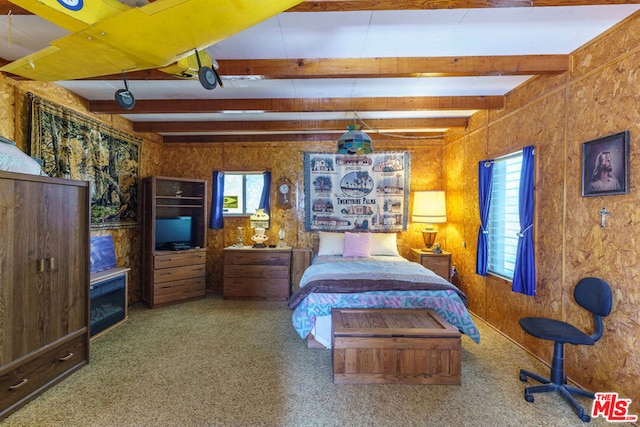 bedroom featuring beam ceiling and carpet floors