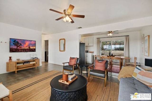 living room featuring dark hardwood / wood-style floors and ceiling fan