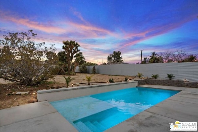 view of pool at dusk