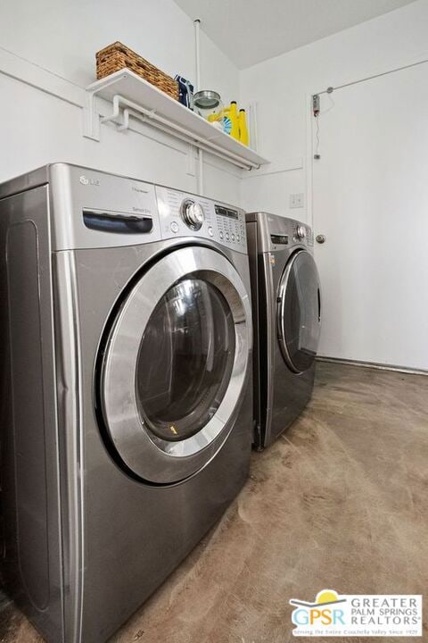 clothes washing area featuring washer and dryer and carpet floors