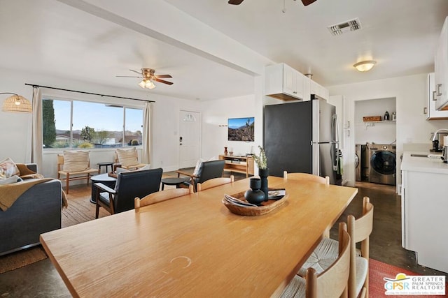 dining area with separate washer and dryer and ceiling fan