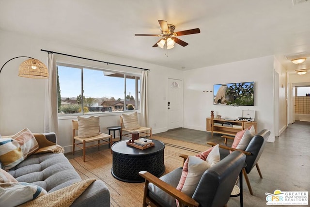 living room with ceiling fan and concrete flooring