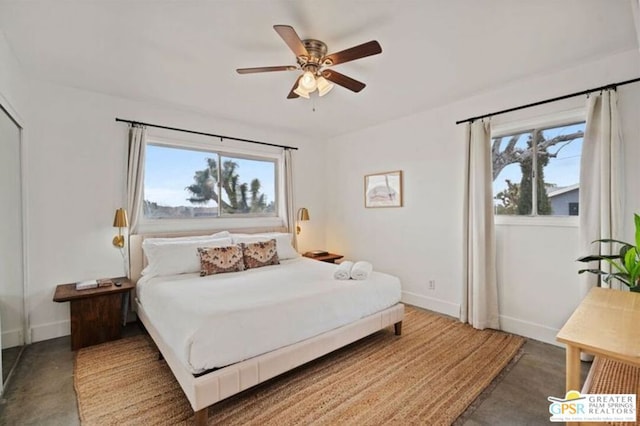 bedroom featuring ceiling fan and concrete floors