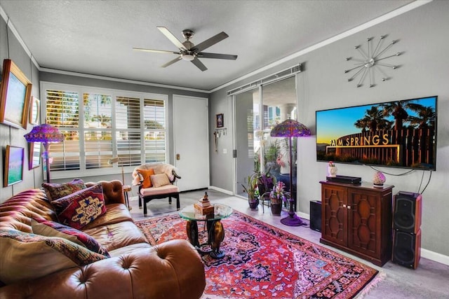 living room with ceiling fan, a textured ceiling, and ornamental molding