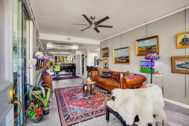 living room featuring ceiling fan and concrete flooring