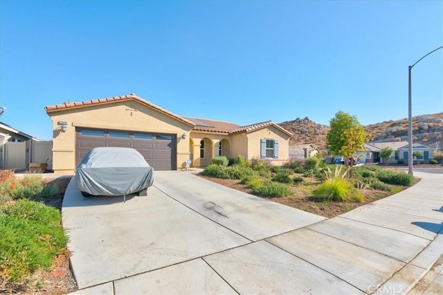 view of front facade featuring a mountain view and a garage