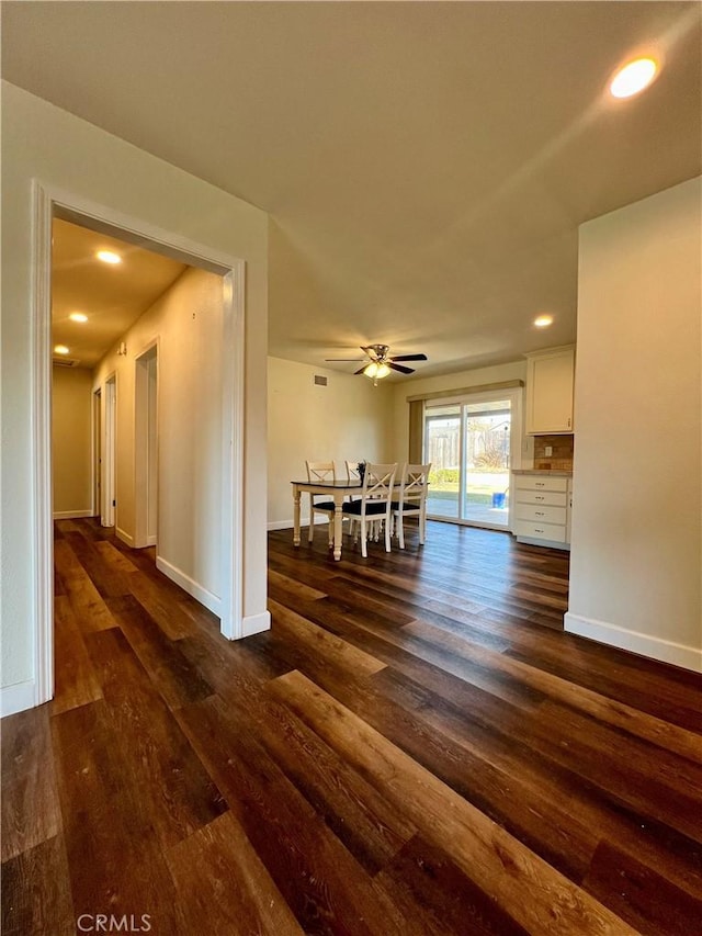 interior space featuring ceiling fan and dark wood-type flooring