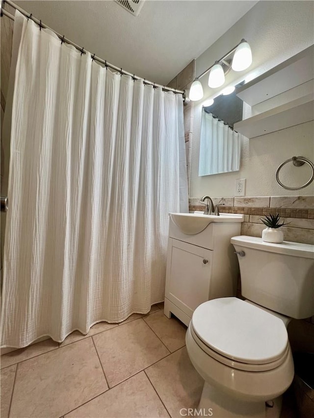 bathroom with tile patterned flooring, vanity, toilet, and a shower with shower curtain