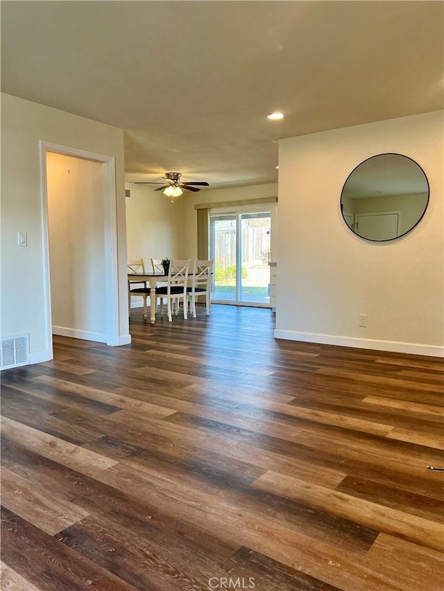 unfurnished room featuring dark hardwood / wood-style floors and ceiling fan