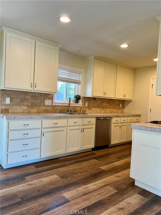 kitchen with white cabinetry, dishwasher, and sink