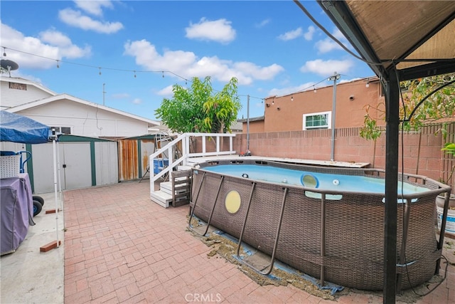 view of swimming pool with a storage unit