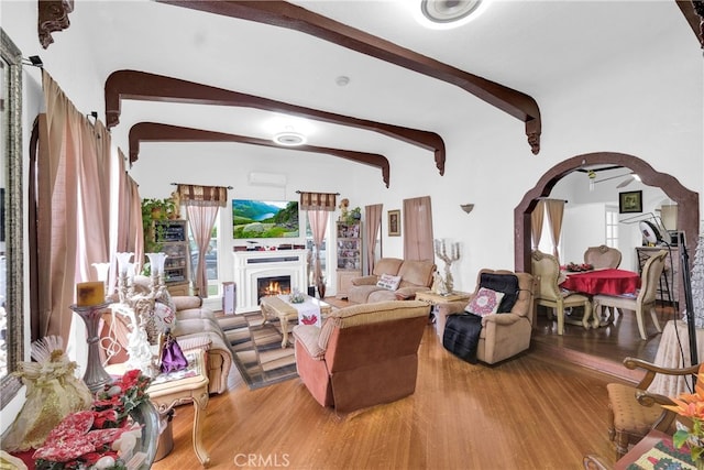 living room with vaulted ceiling with beams and hardwood / wood-style flooring