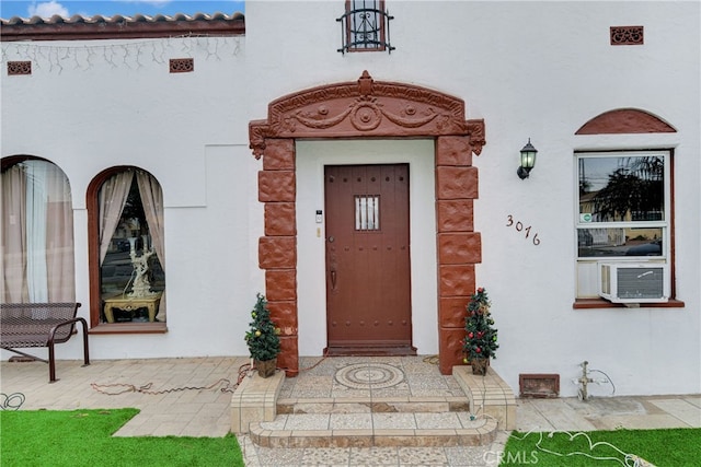 doorway to property featuring cooling unit