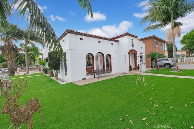 rear view of property featuring a yard