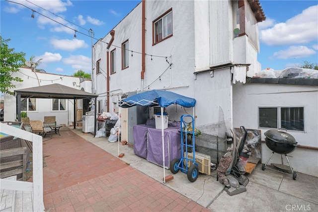 exterior space featuring a gazebo and a grill