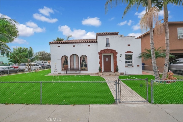 mediterranean / spanish-style house with a front lawn