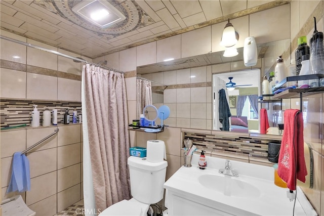 bathroom featuring toilet, tasteful backsplash, tile walls, a shower with shower curtain, and vanity