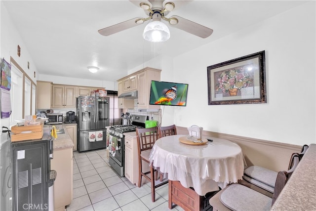 kitchen featuring stainless steel appliances, light brown cabinetry, ceiling fan, and light tile patterned floors