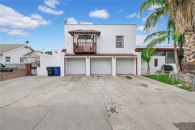 view of front facade featuring a balcony and a garage