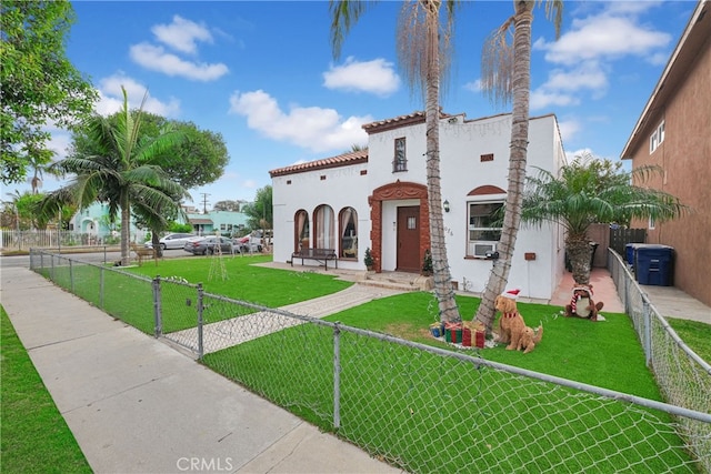 mediterranean / spanish house featuring a front yard