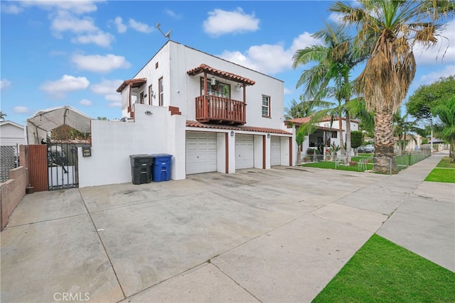 view of front facade with a balcony and a garage