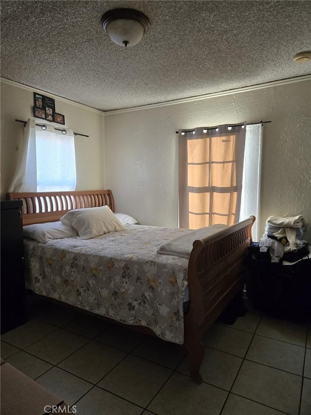 tiled bedroom featuring a textured ceiling, crown molding, and multiple windows