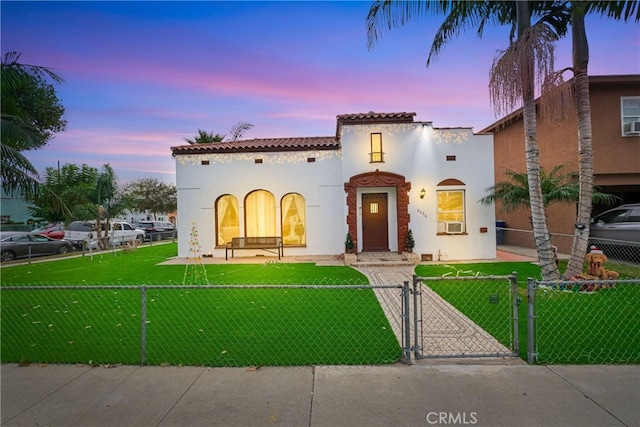 mediterranean / spanish home featuring a yard