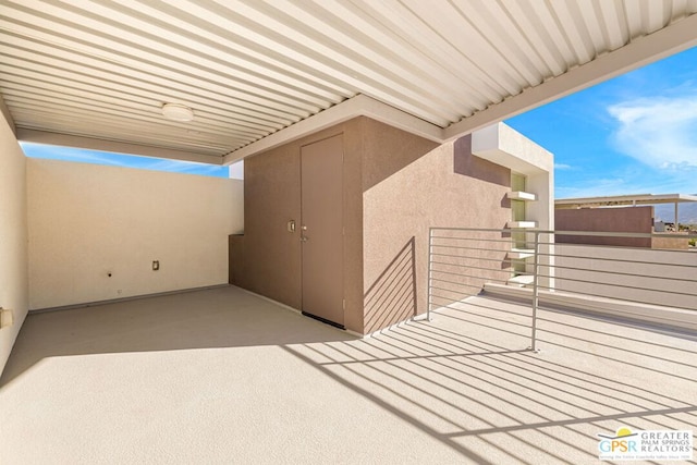 view of patio featuring a balcony