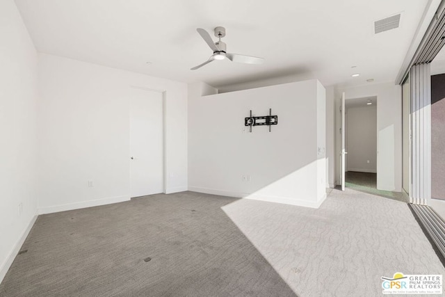 spare room featuring carpet flooring and ceiling fan