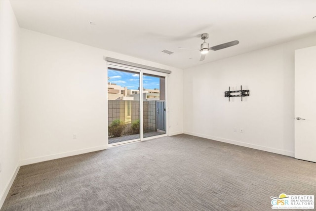 carpeted spare room featuring ceiling fan