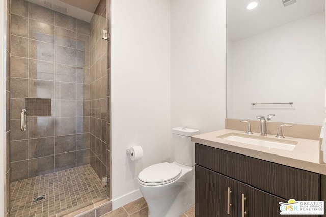 bathroom with tile patterned flooring, vanity, an enclosed shower, and toilet