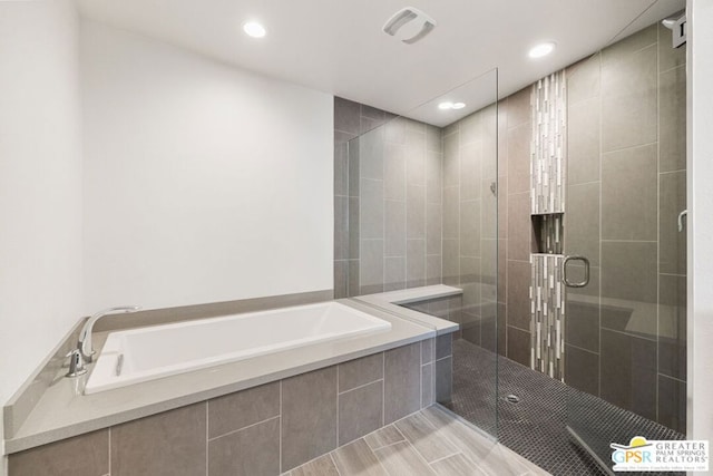 bathroom with shower with separate bathtub