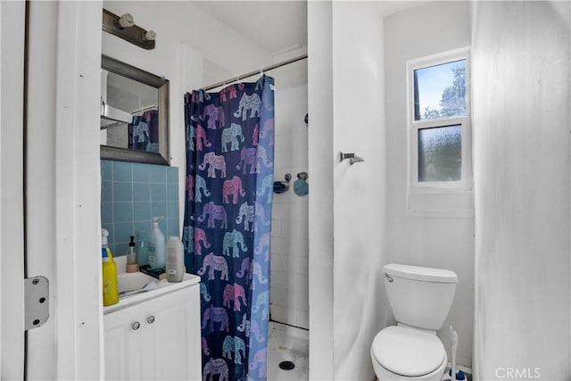 bathroom with a shower with shower curtain and toilet